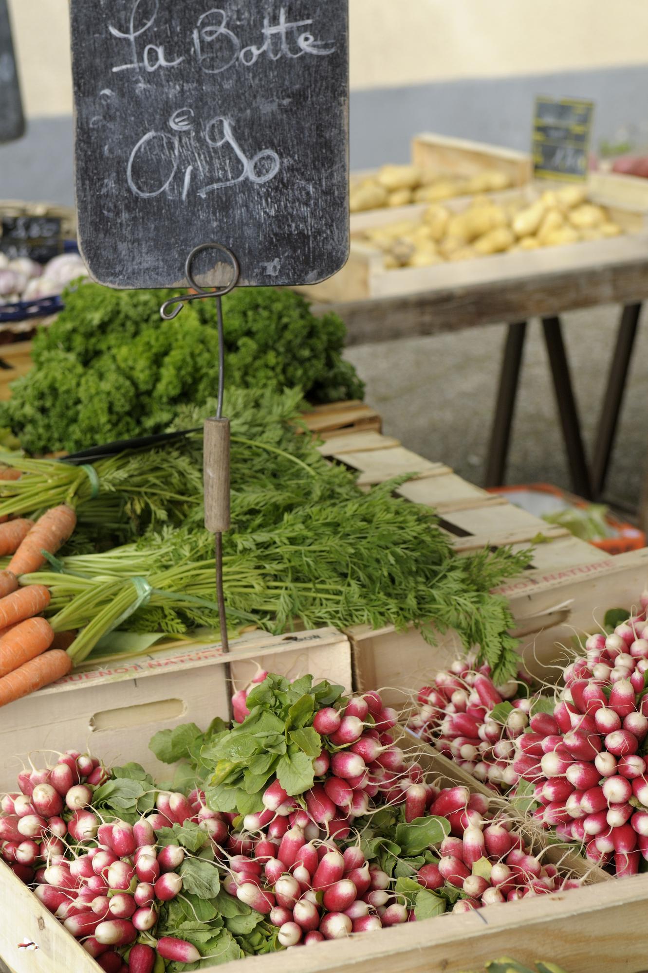 Regional ingredients on market stall with herbs and vegetables