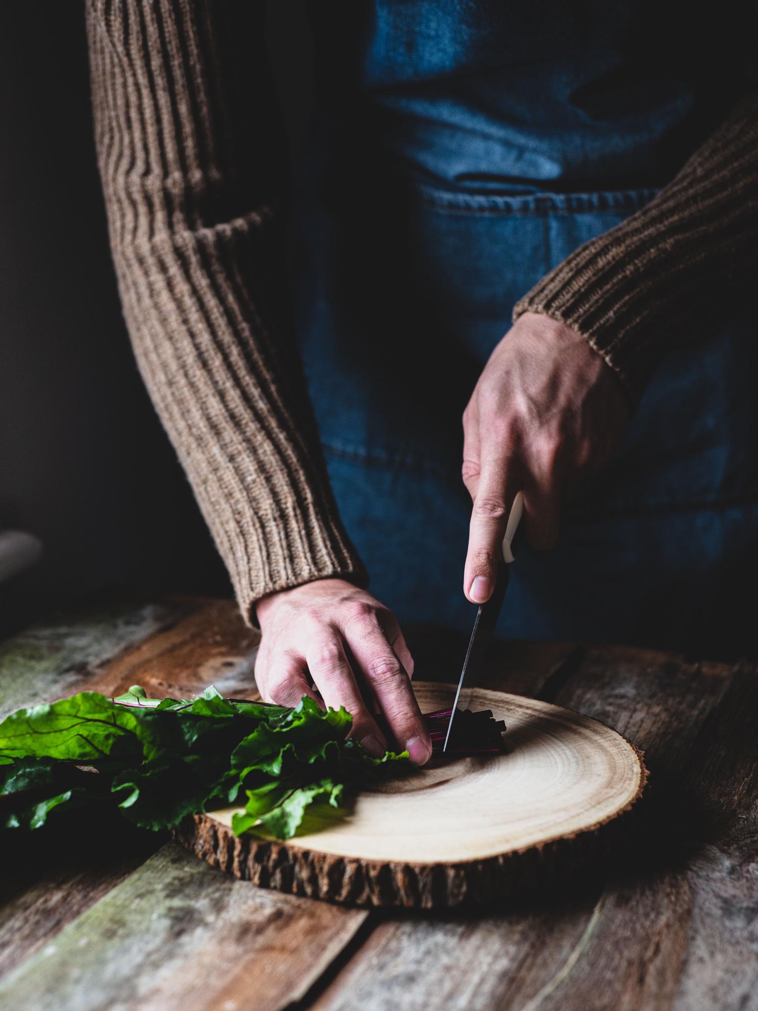 Chef preparing a rustic plate on wooden table